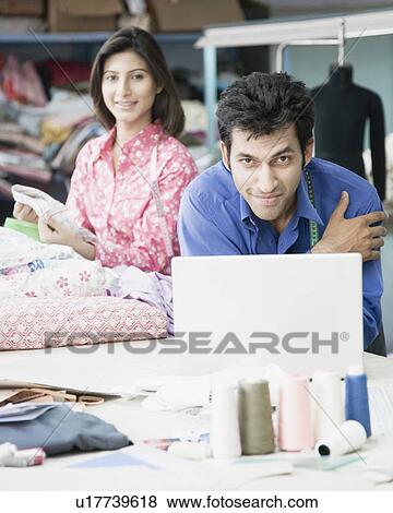 Portrait of two fashion designers in a textile industry View Large Photo Image Stock Photo - Portrait of two fashion designers in a textile industry. Fotosearch