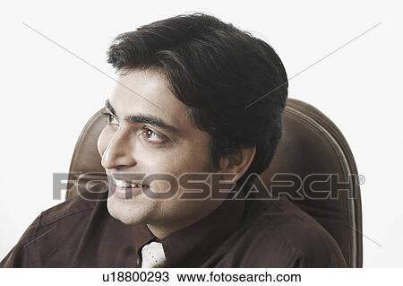 Close-up of a businessman smiling View Large Photo Image Stock Image - Close-up of a businessman smiling. Fotosearch
