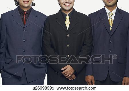 Stock Photography - Close-up of three businessmen standing side by side. Fotosearch