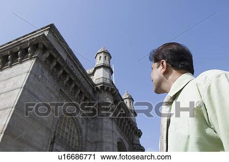 Low angle view of a businessman in front of a monument, Gateway of India, Mumbai, Maharashtra, India View Large Photo Image Stock Image - Low angle view of a businessman in front of a monument, Gateway of India, Mumbai, Maharashtra, India. Fotosearch