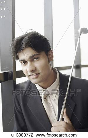 Portrait of a businessman holding a golf club View Large Photo Image Stock Image - Portrait of a businessman holding a golf club. Fotosearch
