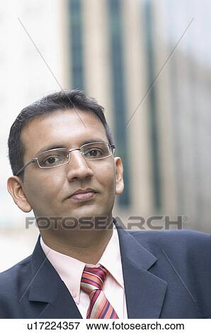 Stock Photo - Portrait of a businessman looking confident, Singapore. Fotosearch