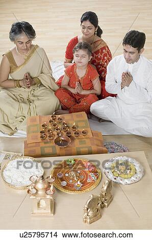 High angle view of a family doing Lakshmi pujan View Large Photo Image Picture - High angle view of a family doing Lakshmi pujan. Fotosearch
