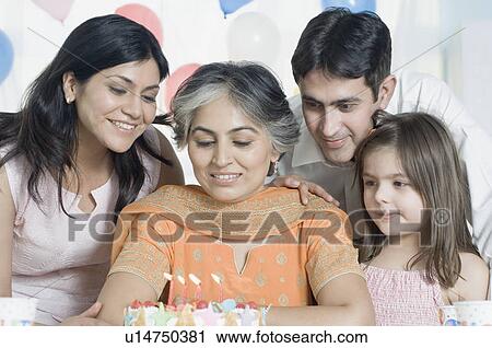 Mature woman celebrating her birthday with her family View Large Photo Image Stock Image - Mature woman celebrating her birthday with her family. Fotosearch