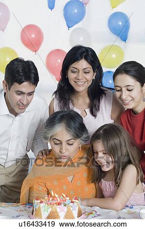 Mature woman celebrating her birthday with her family View Large Photo Image Stock Photo - Mature woman celebrating her birthday with her family. Fotosearch