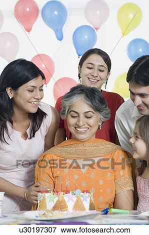 Mature woman celebrating her birthday with her friends View Large Photo Image Stock Photo - Mature woman celebrating her birthday with her friends. Fotosearch