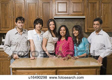 Portrait of a group of people smiling and standing in the kitchen View Large Photo Image Stock Photo - Portrait of a group of people smiling and standing in the kitchen. Fotosearch