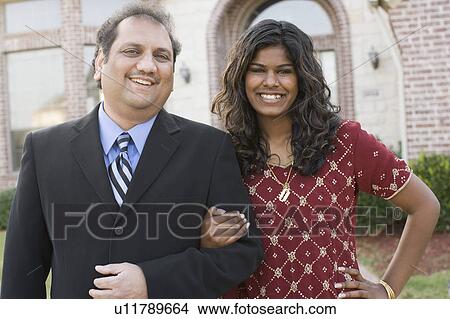 Portrait of a mature man and his daughter smiling with their arm in arm View Large Photo Image Picture - Portrait of a mature man and his daughter smiling with their arm in arm. Fotosearch