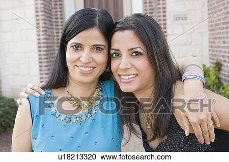 Portrait of a mature woman arm around her daughter and smiling View Large Photo Image Stock Image - Portrait of a mature woman arm around her daughter and smiling. Fotosearch