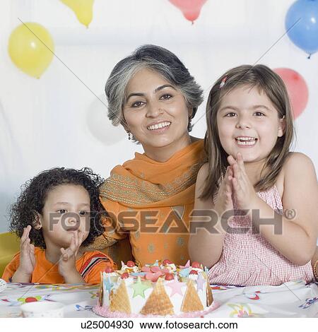 Portrait of a mature woman celebrating her birthday with her two granddaughters View Large Photo Image Stock Image - Portrait of a mature woman celebrating her birthday with her two granddaughters. Fotosearch