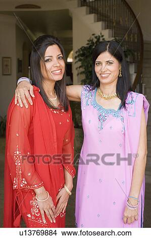 Portrait of a mature woman smiling with her daughter View Large Photo Image Picture - Portrait of a mature woman smiling with her daughter. Fotosearch