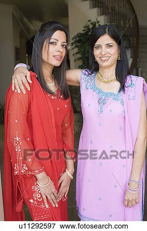Portrait of a mature woman smiling with her daughter View Large Photo Image Stock Photo - Portrait of a mature woman smiling with her daughter. Fotosearch