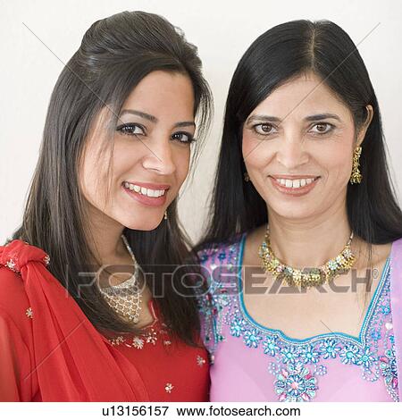 Portrait of a mature woman smiling with her daughter View Large Photo Image Stock Photo - Portrait of a mature woman smiling with her daughter. Fotosearch