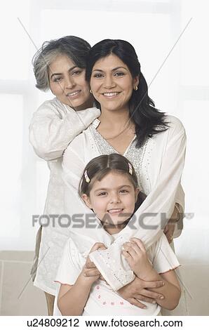 Portrait of a mature woman with her daughter and granddaughter smiling View Large Photo Image Stock Image - Portrait of a mature woman with her daughter and granddaughter smiling. Fotosearch