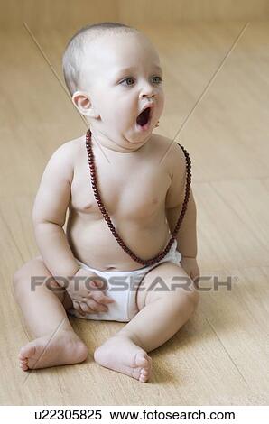 Baby boy sitting on the hardwood floor and yawning View Large Photo Image Stock Photography - Baby boy sitting on the hardwood floor and yawning. Fotosearch