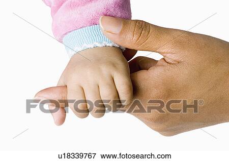 Baby holding a person's finger View Large Photo Image Stock Photo - Baby holding a person's finger. Fotosearch