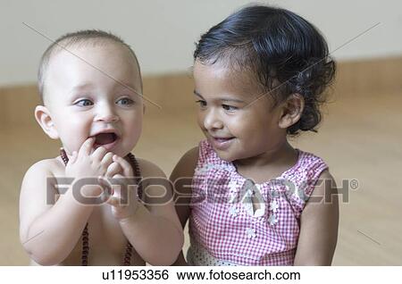 Stock Photograph - Close-up of a baby boy and a girl smiling. Fotosearch