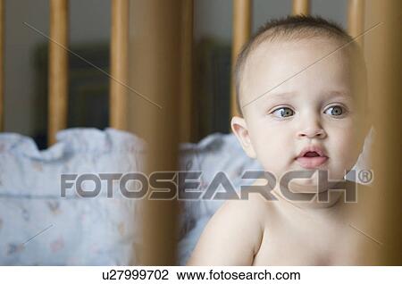 Stock Image - Close-up of a baby boy looking away. Fotosearch