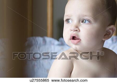 Close-up of a baby boy looking away View Large Photo Image Stock Photography - Close-up of a baby boy looking away. Fotosearch