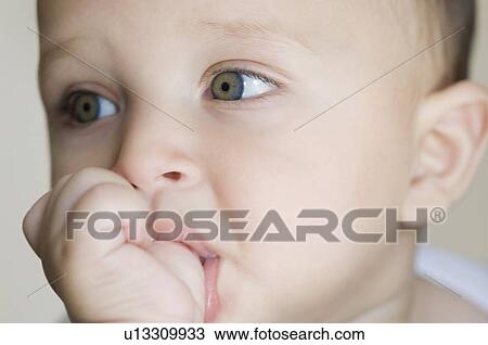 Close-up of a baby boy thumb sucking View Large Photo Image Stock Image - Close-up of a baby boy thumb sucking. Fotosearch