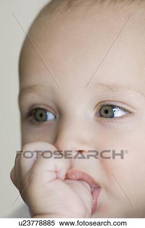 Close-up of a baby boy thumb sucking View Large Photo Image Stock Photography - Close-up of a baby boy thumb sucking. Fotosearch