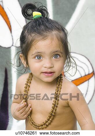 Close-up of a baby girl wearing a necklace View Large Photo Image Stock Image - Close-up of a baby girl wearing a necklace. Fotosearch