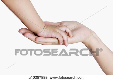 Close-up of a child hand touching her mother's hand View Large Photo Image Stock Photo - Close-up of a child hand touching her mother's hand. Fotosearch