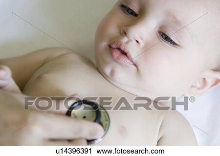 Close-up of a person's hand examining a baby boy with a stethoscope View Large Photo Image Stock Image - Close-up of a person's hand examining a baby boy with a stethoscope. Fotosearch
