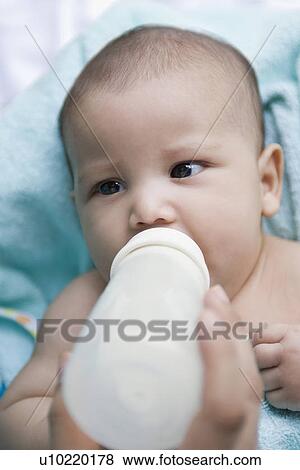 Close-up of a person's hand feeding a baby boy with a baby bottle View Large Photo Image Stock Photo - Close-up of a person's hand feeding a baby boy with a baby bottle. Fotosearch