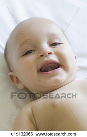Portrait of a baby lying down and smiling View Large Photo Image Stock Photograph - Portrait of a baby lying down and smiling. Fotosearch