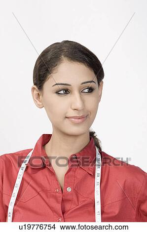 Close-up of a female fashion designer looking away View Large Photo Image Picture - Close-up of a female fashion designer looking away. Fotosearch