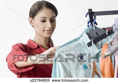 Close-up of a female fashion designer looking at designers clothes View Large Photo Image Stock Photo - Close-up of a female fashion designer looking at designers clothes. Fotosearch