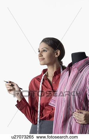 Female fashion designer hugging a mannequin and smiling View Large Photo Image Stock Photography - Female fashion designer hugging a mannequin and smiling. Fotosearch