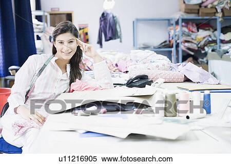 Portrait of a female fashion designer smiling View Large Photo Image Stock Photography - Portrait of a female fashion designer smiling. Fotosearch