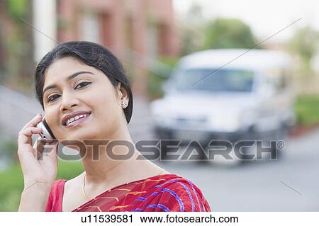 Portrait of a mid adult woman talking on a mobile phone View Large Photo Image Stock Image - Portrait of a mid adult woman talking on a mobile phone. Fotosearch