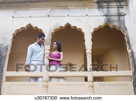 Low angle view of a young couple leaning against a column of a palace, Neemrana Fort Palace, Neemrana, Alwar, Rajasthan, India View Large Photo Image Stock Image - Low angle view of a young couple leaning against a column of a palace, Neemrana Fort Palace, Neemrana, Alwar, Rajasthan, India. Fotosearch