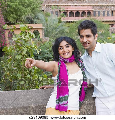 Young couple leaning against a wall and smiling with a palace in the background, Neemrana Fort Palace, Neemrana, Alwar, Rajasthan, India View Large Photo Image Stock Photography - Young couple leaning against a wall and smiling with a palace in the background, Neemrana Fort Palace, Neemrana, Alwar, Rajasthan, India. Fotosearch