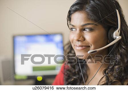 Close-up of a young woman wearing a headset and listening to music View Large Photo Image Stock Photograph - Close-up of a young woman wearing a headset and listening to music. Fotosearch