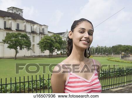 Portrait of a young woman smiling, Se Cathedral, Goa, India View Large Photo Image Stock Photograph - Portrait of a young woman smiling, Se Cathedral, Goa, India. Fotosearch