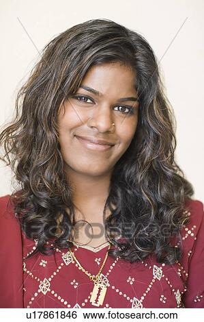 Stock Photograph - Portrait of a young woman smirking. Fotosearch