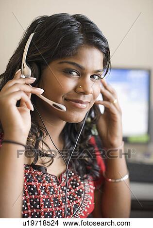 Portrait of a young woman wearing a headset and listening to music View Large Photo Image Picture - Portrait of a young woman wearing a headset and listening to music. Fotosearch
