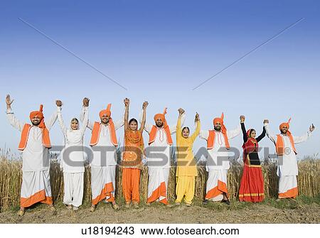 Stock Image - Four young couples standing side by side with holding each others hands. Fotosearch