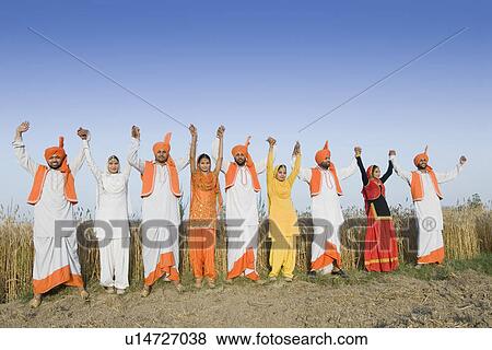 Stock Photo - Four young couples standing side by side with holding each others hands. Fotosearch