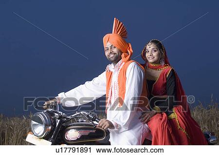 Portrait of a young couple on a motorcycle View Large Photo Image Stock Image - Portrait of a young couple on a motorcycle. Fotosearch