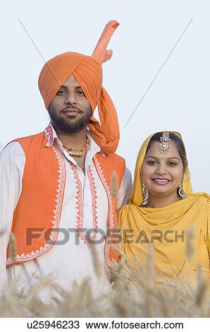 Portrait of a young couple standing in a wheat field and smiling View Large Photo Image Stock Image - Portrait of a young couple standing in a wheat field and smiling. Fotosearch