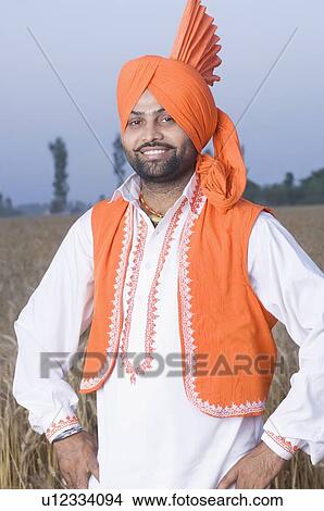 Portrait of a young man standing in a wheat field View Large Photo Image Picture - Portrait of a young man standing in a wheat field. Fotosearch