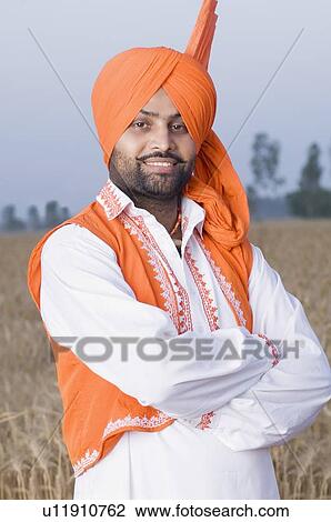 Portrait of a young man standing in a wheat field View Large Photo Image Stock Image - Portrait of a young man standing in a wheat field. Fotosearch