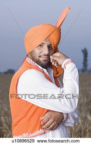Portrait of a young man twisting his mustache View Large Photo Image Stock Photo - Portrait of a young man twisting his mustache. Fotosearch
