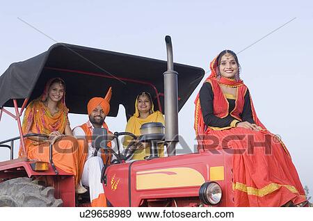 Portrait of a young man with three young women on a tractor View Large Photo Image Stock Photo - Portrait of a young man with three young women on a tractor. Fotosearch