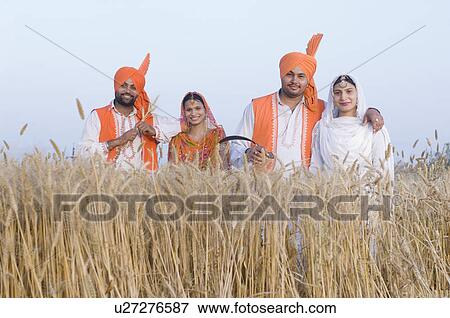 Portrait of two young couples standing in a wheat field View Large Photo Image Stock Photo - Portrait of two young couples standing in a wheat field. Fotosearch